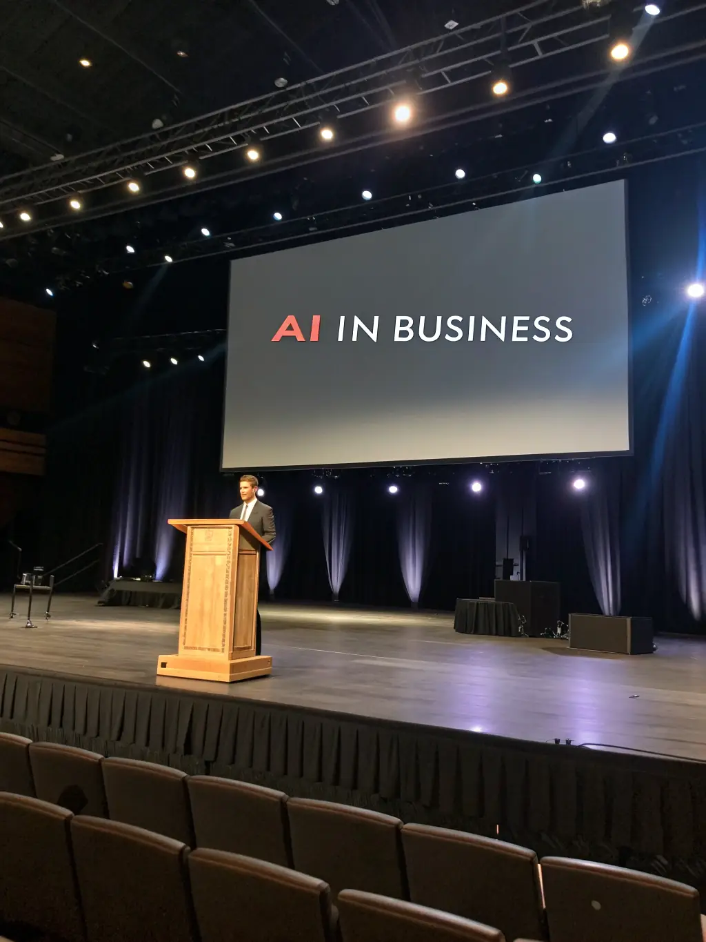 A photograph of a technology conference in Hyderabad, India, with a focus on AI and machine learning, showcasing speakers and attendees.