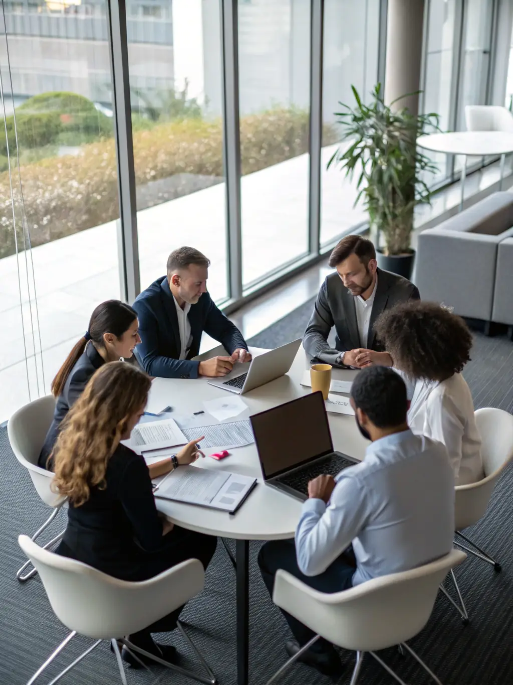 A professional photograph of a corporate gathering in Delhi, India, featuring executives participating in workshops and team-building activities.
